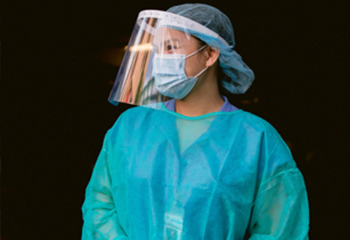 Nurse wearing scrubs and mask