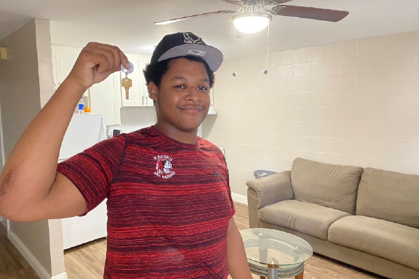 Young man holding a key
